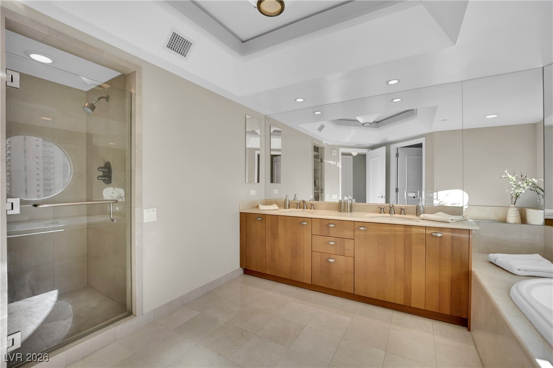 2777 Paradise Road, Unit 1803 Las Vegas, NV 89109 - Photo 23 of 48 Full bath featuring double vanity, a shower stall, recessed lighting, and a bathtub