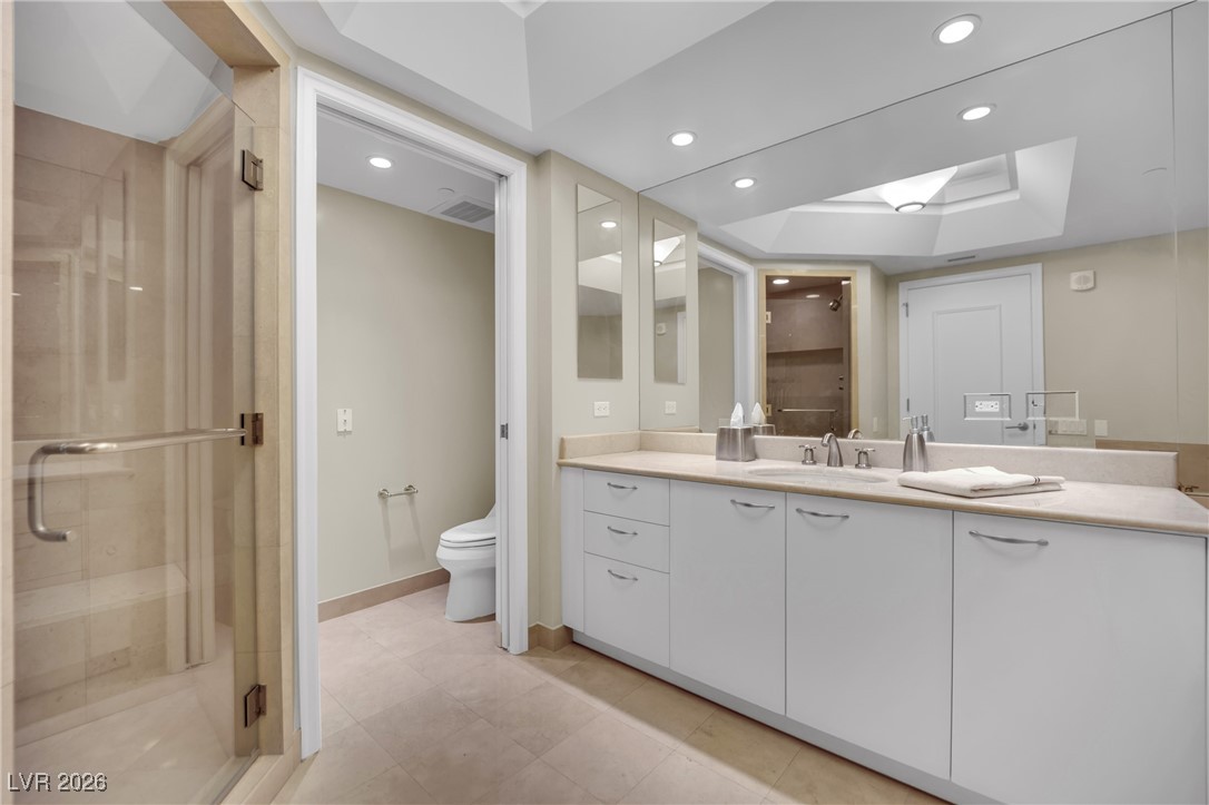 2777 Paradise Road, Unit 1803 Las Vegas, NV 89109 - Photo 32 of 48 Bathroom with a shower stall, vanity, recessed lighting, a tray ceiling, and a skylight