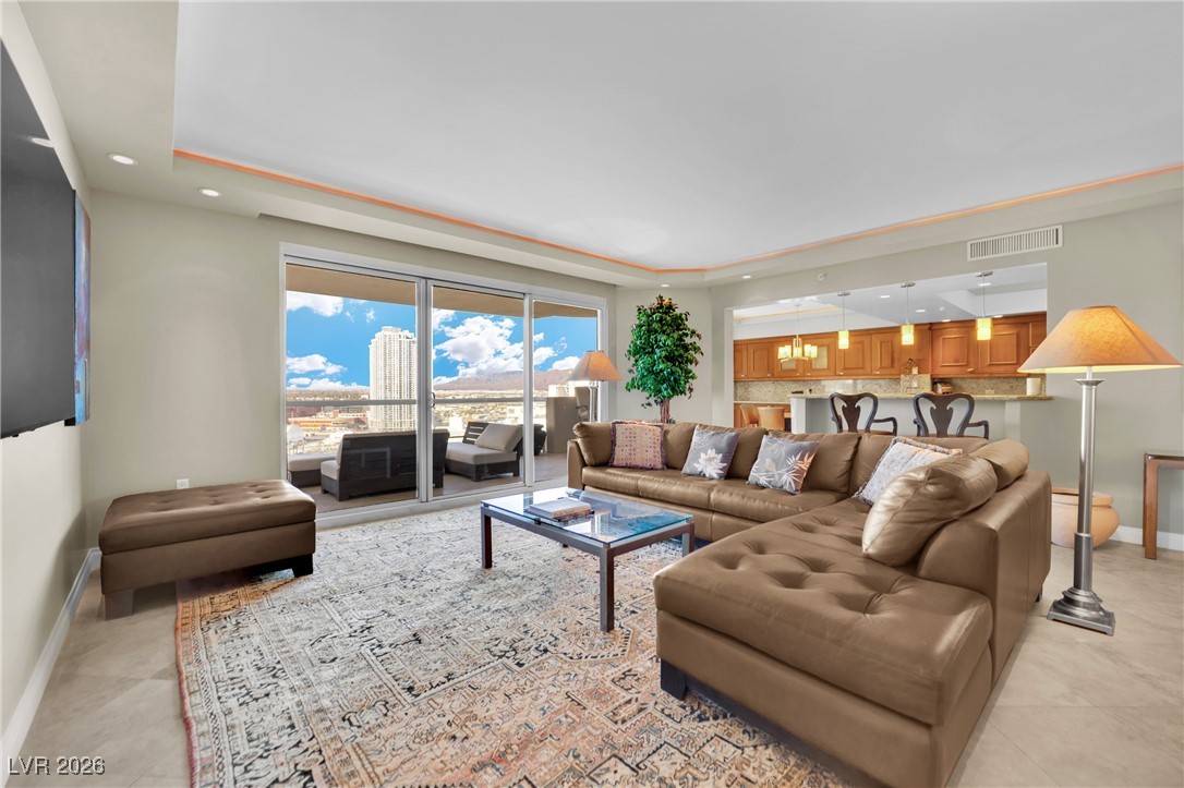 2777 Paradise Road, Unit 1803 Las Vegas, NV 89109 - Photo 5 of 48 Living room with a tray ceiling, recessed lighting, and light tile patterned flooring