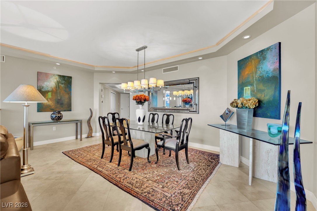 2777 Paradise Road, Unit 1803 Las Vegas, NV 89109 - Photo 7 of 48 Dining area featuring a tray ceiling, recessed lighting, and a chandelier