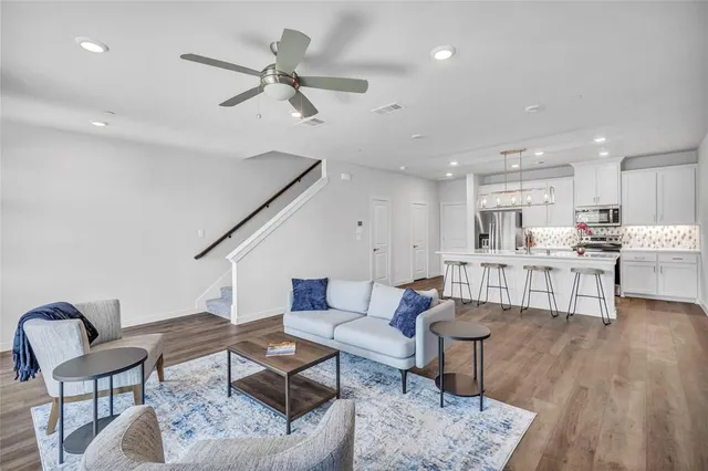 a living room with furniture and kitchen view