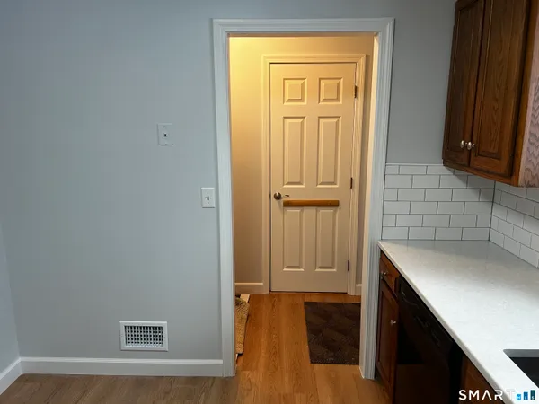 a bathroom with a granite countertop sink and mirror