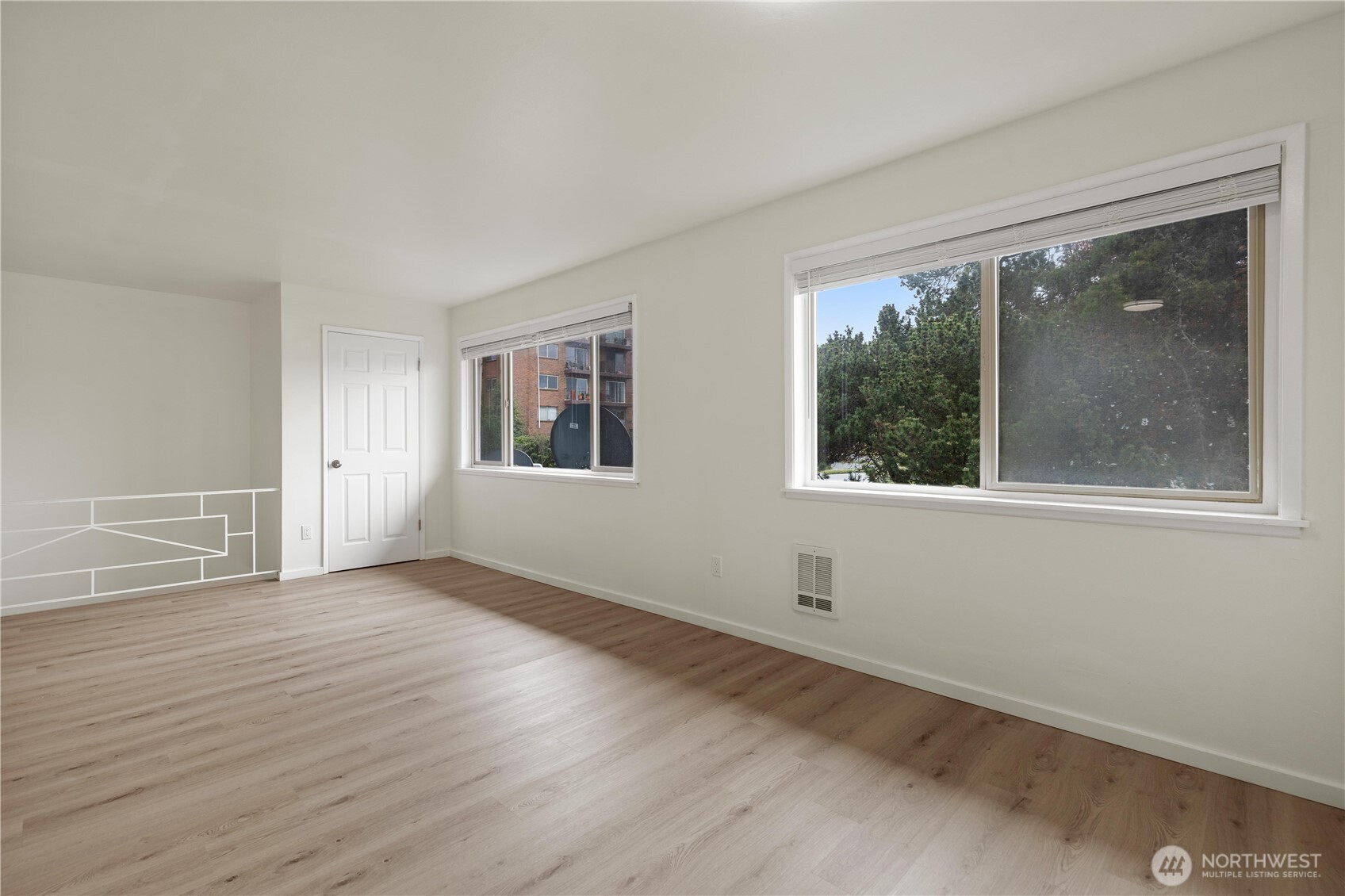 2614 Rucker Avenue Everett, WA 98201 - Photo 11 of 17 a view of an empty room with wooden floor and a window