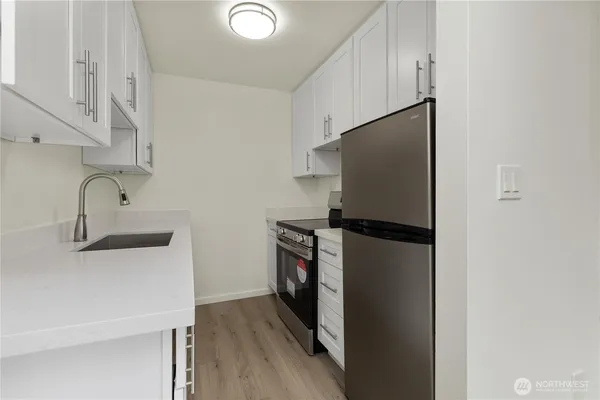 a kitchen with a stove and a refrigerator