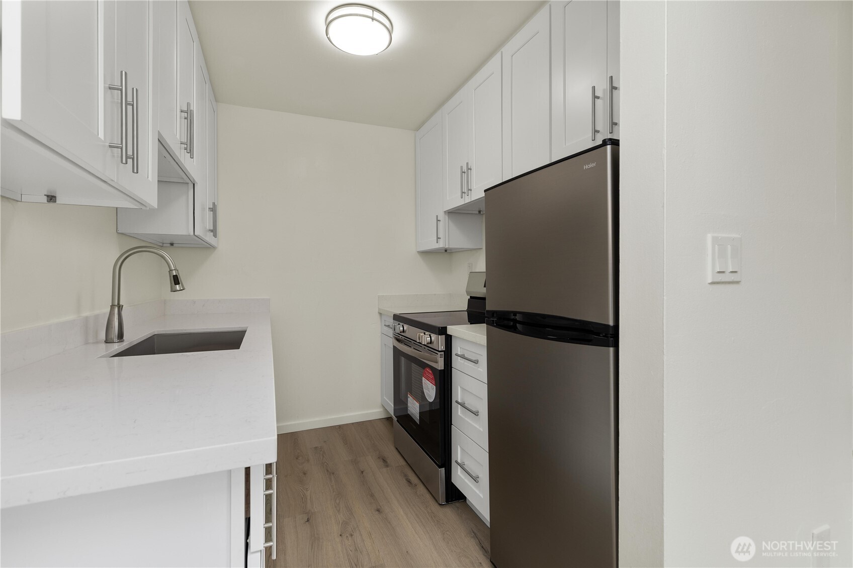 2614 Rucker Avenue Everett, WA 98201 - Photo 12 of 17 a kitchen with stainless steel appliances a refrigerator and a sink