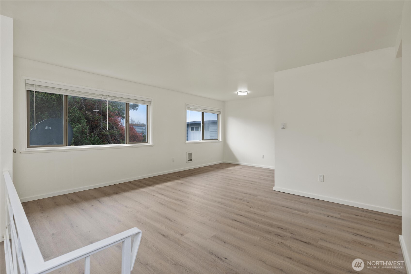 2614 Rucker Avenue Everett, WA 98201 - Photo 7 of 17 an empty room with wooden floor and windows
