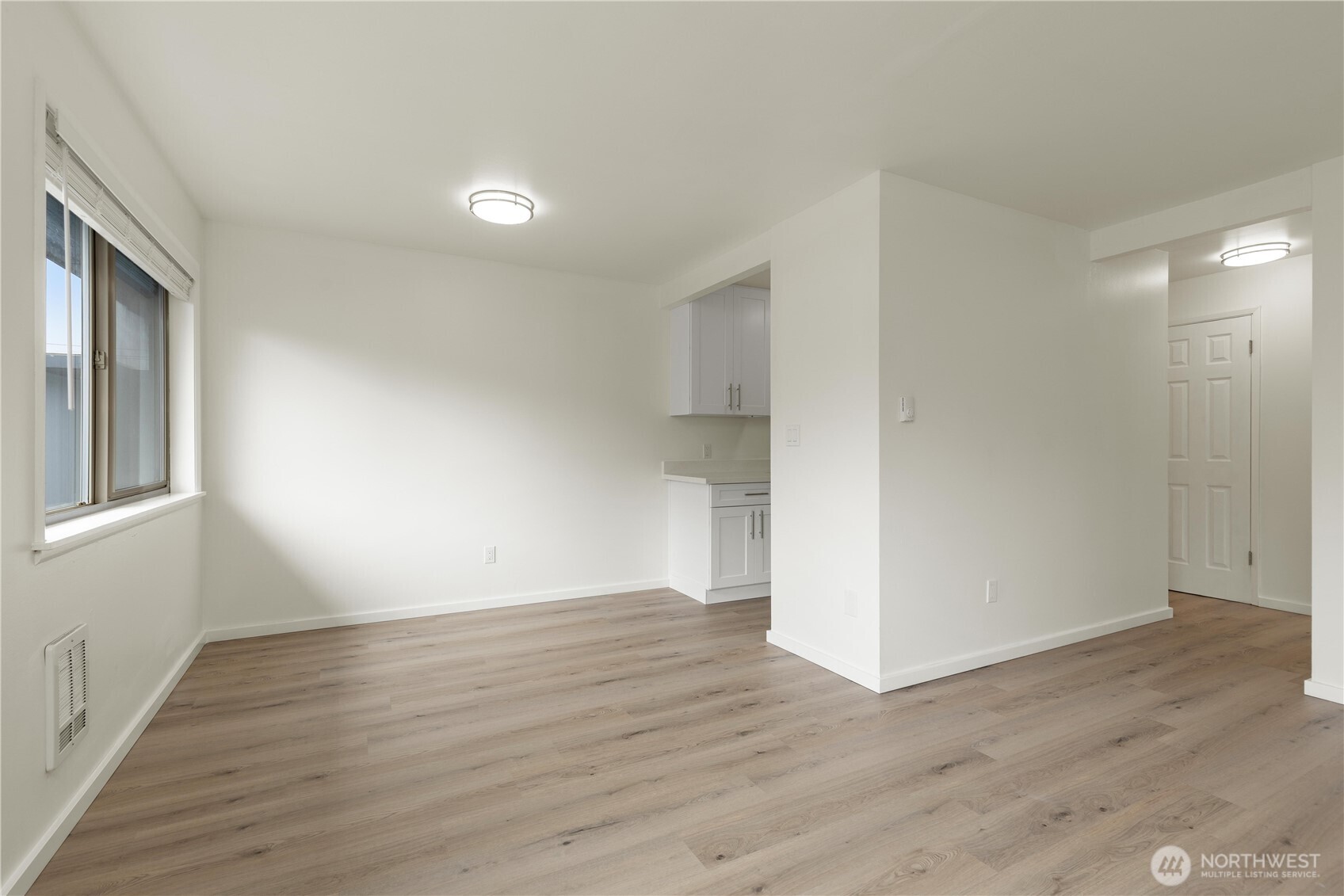 2614 Rucker Avenue Everett, WA 98201 - Photo 9 of 17 a view of an empty room with wooden floor and a window