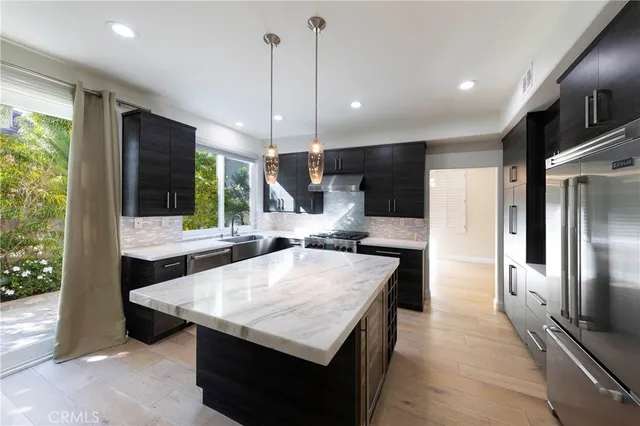 a large kitchen with a table and chairs