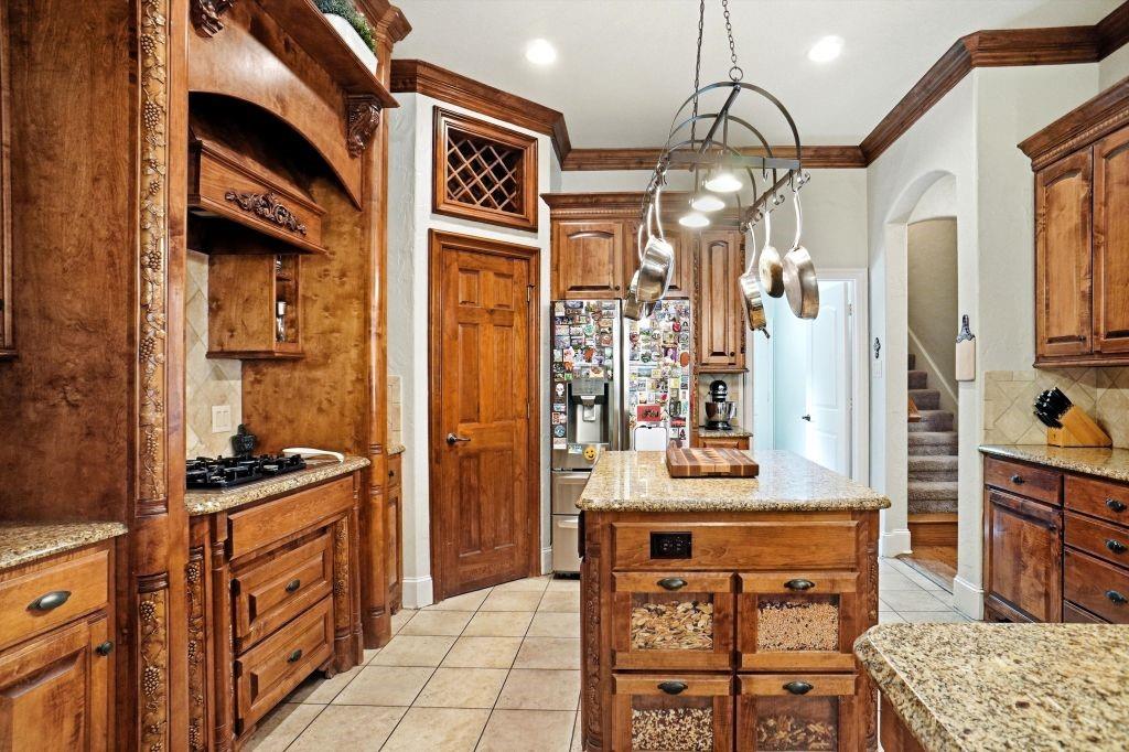 620 Highview Lane Hurst, TX 76054 - Photo 21 of 40 a kitchen with stainless steel appliances granite countertop a stove a sink and a refrigerator