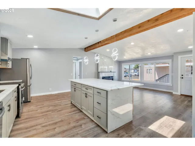 a kitchen with stainless steel appliances granite countertop a stove and a refrigerator