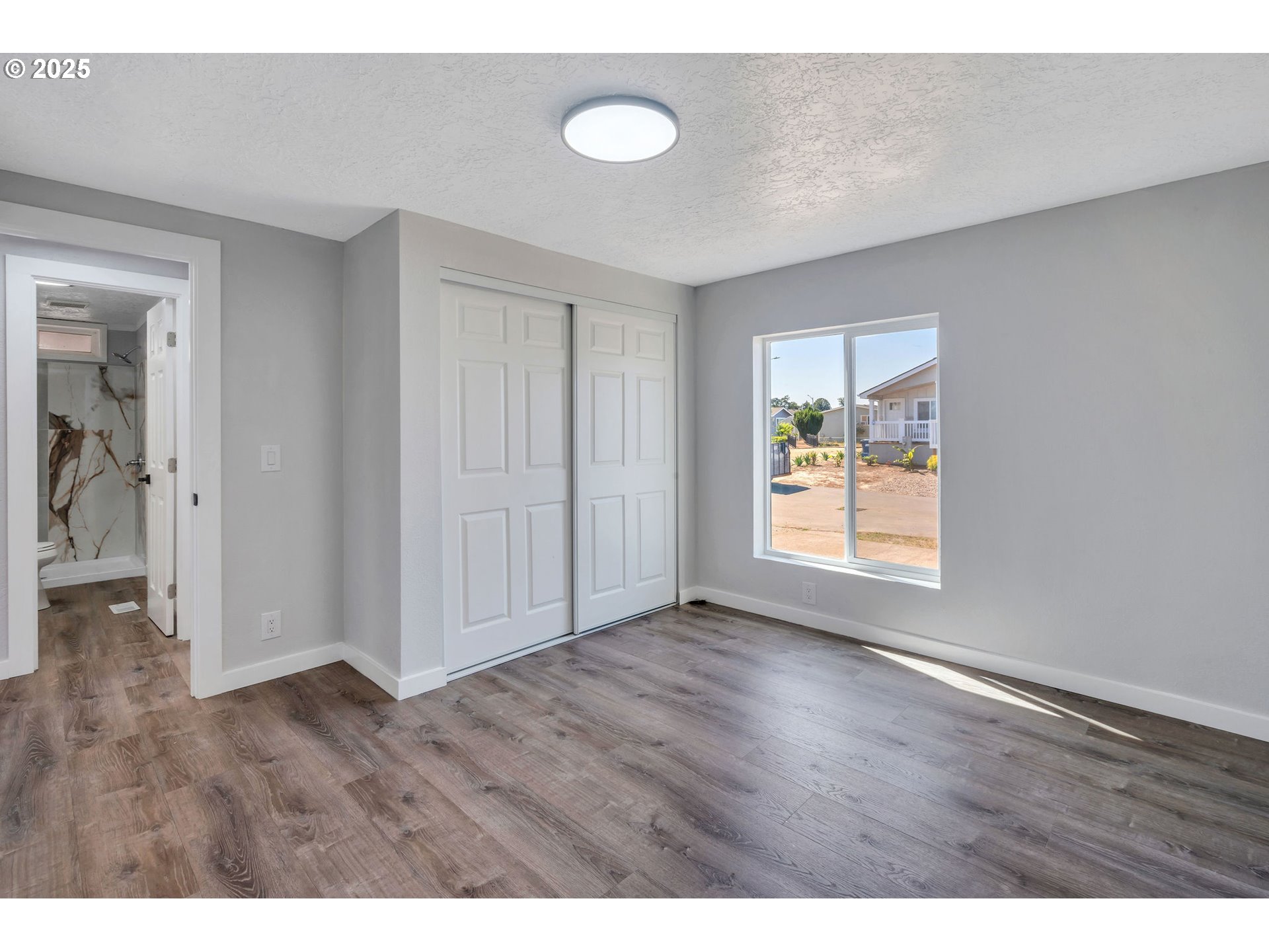 3554 Turner Road Southeast Salem, OR 97302 - Photo 16 of 26 a view of an empty room with wooden floor and a window