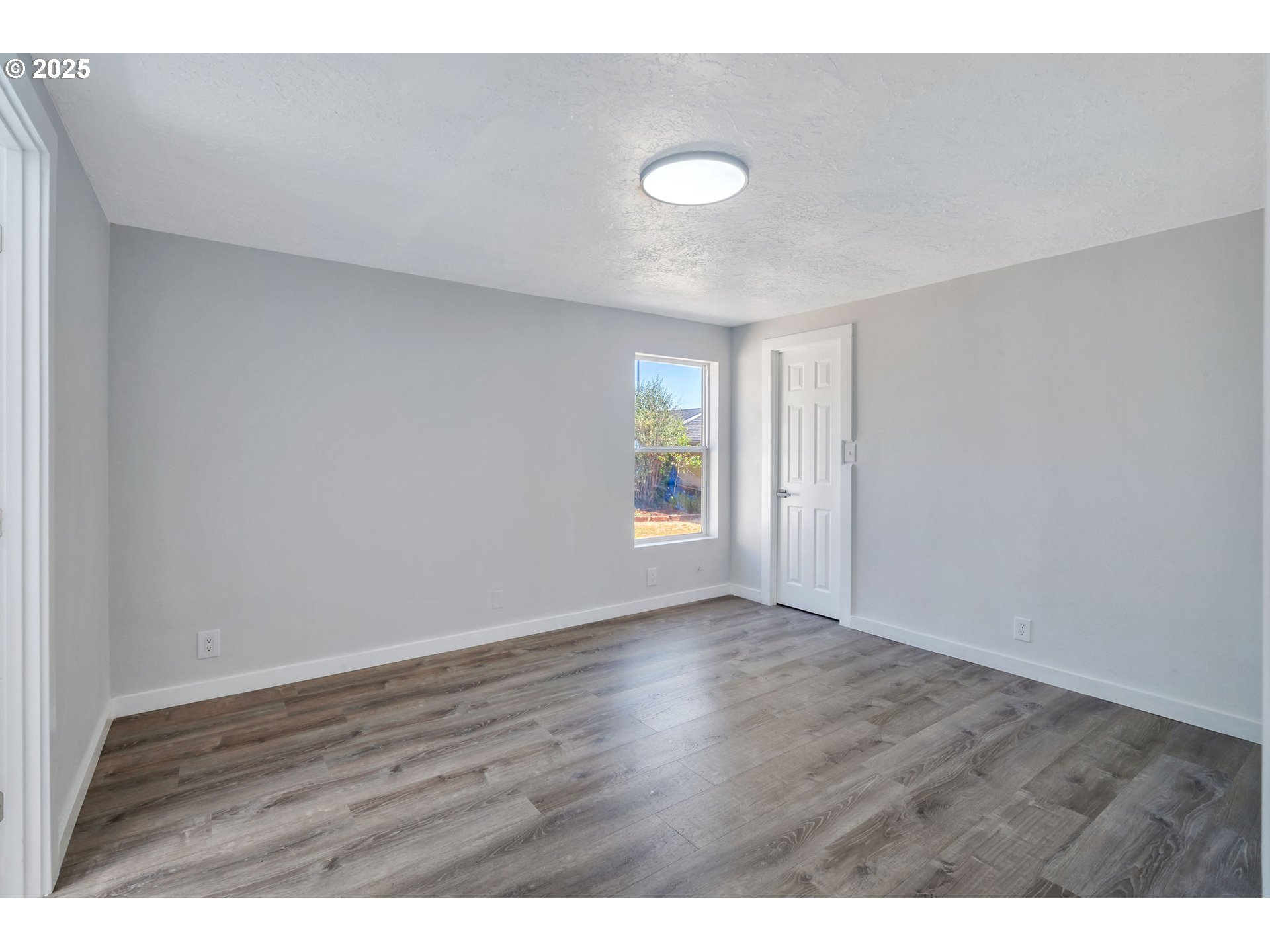 3554 Turner Road Southeast Salem, OR 97302 - Photo 17 of 26 a view of an empty room with wooden floor and a window
