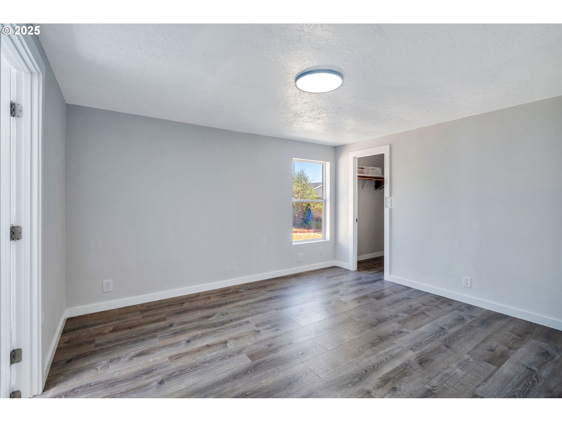 3554 Turner Road Southeast Salem, OR 97302 - Photo 18 of 26 a view of an empty room with window and wooden floor
