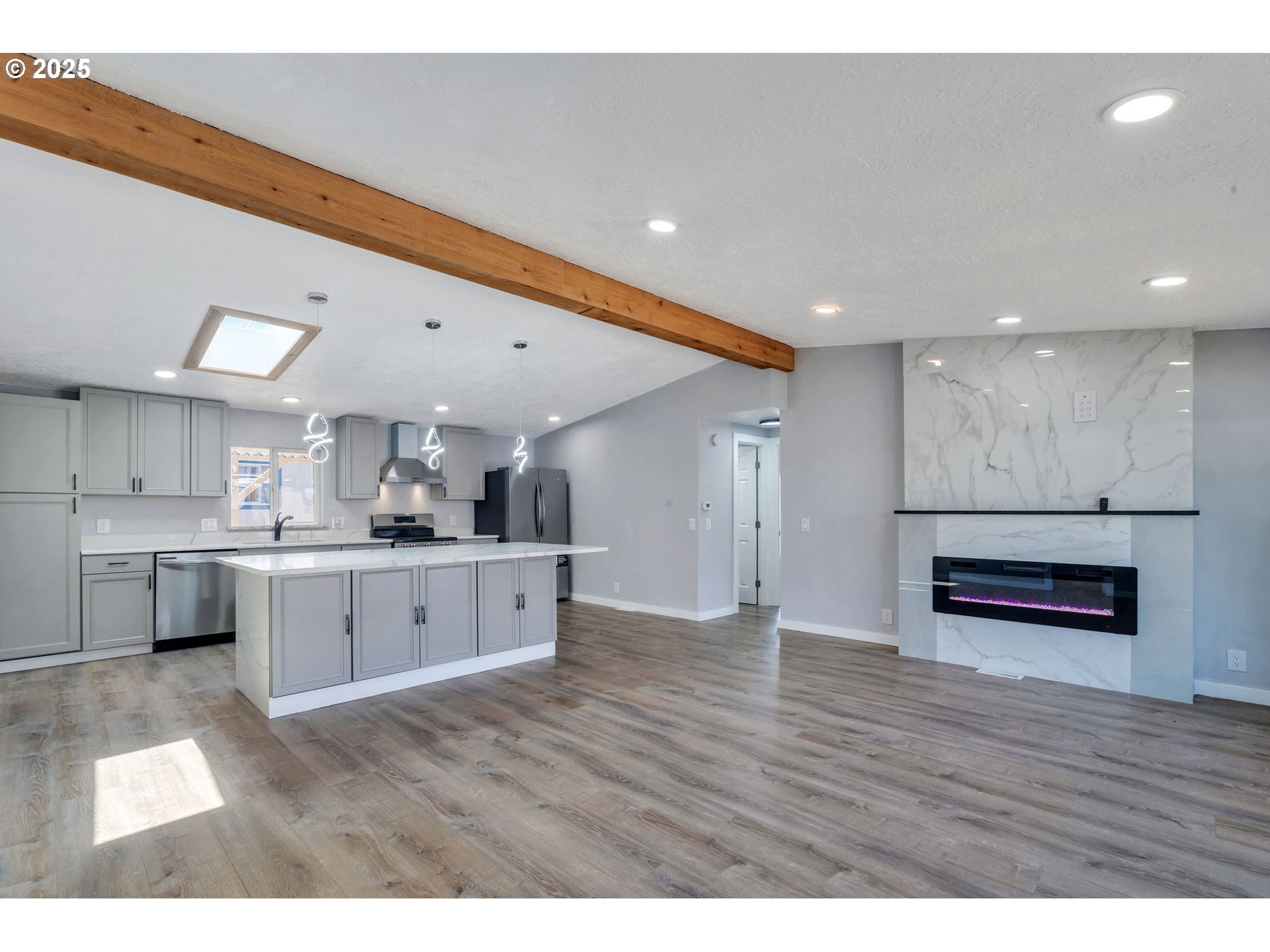 3554 Turner Road Southeast Salem, OR 97302 - Photo 7 of 26 a open kitchen with stainless steel appliances granite countertop a refrigerator a sink dishwasher a stove and white countertops with wooden floor