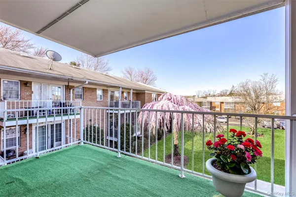 a view of a house with wooden deck and a garden