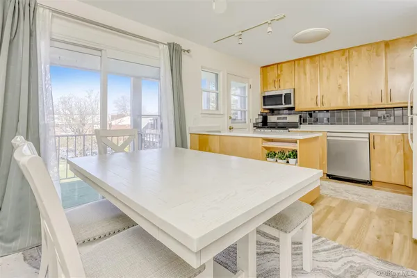 a large kitchen with kitchen island a large window a sink and counter space