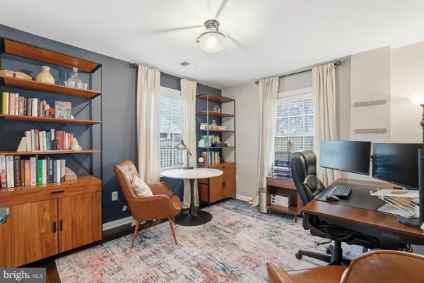 a livingroom with workspace and a couch