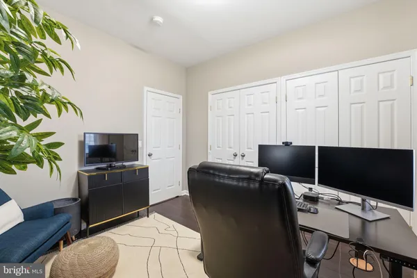 a living room with furniture and a dining table