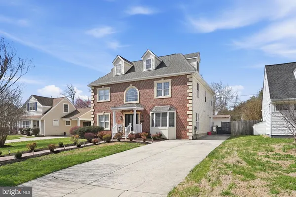 a large kitchen with stainless steel appliances a stove a sink dishwasher and a dining table with the living room view