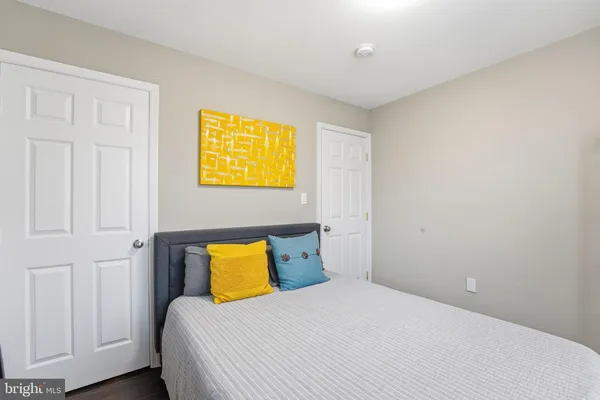 a bedroom with a bed chandelier and a window