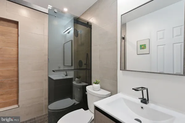 a bathroom with a tub a sink and a shower