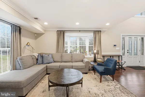 a living room with furniture and kitchen view