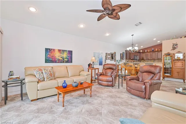 a living room with furniture and a ceiling fan