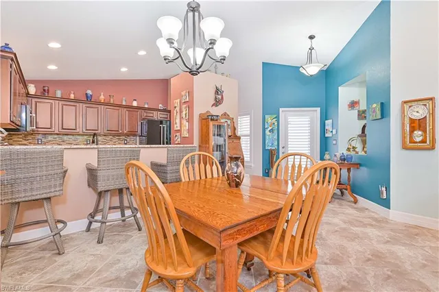 a view of a dining room with furniture a chandelier and wooden floor
