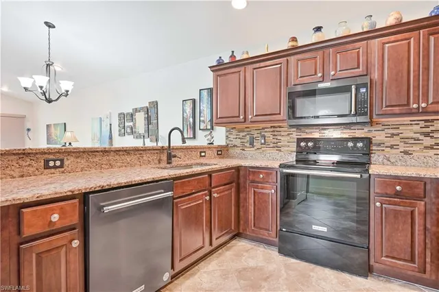 a kitchen with stainless steel appliances granite countertop a stove sink and cabinets
