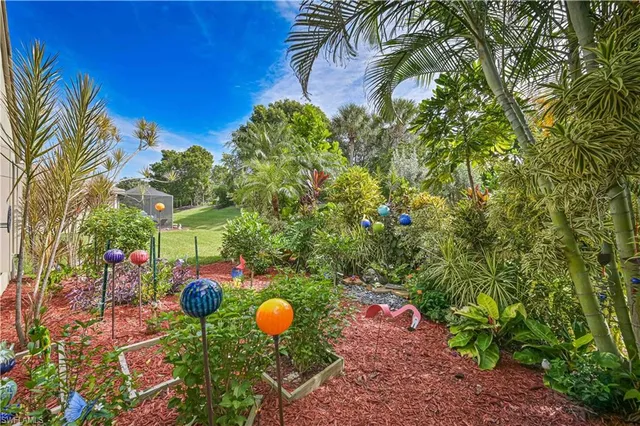 a backyard of a house with a table and chairs