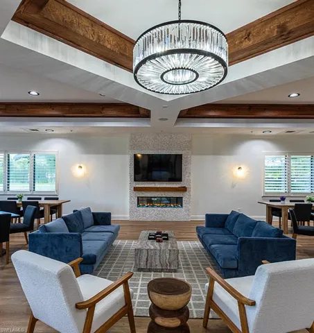 a living room with furniture a window and a chandelier