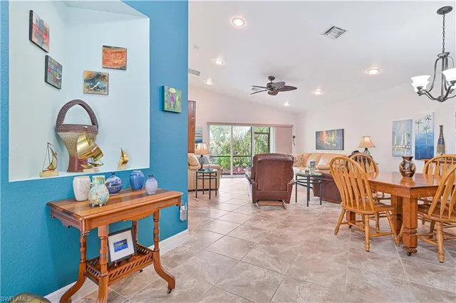 a living room with furniture a dining table and a piano