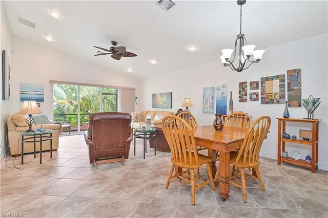 a view of a dining room with furniture a chandelier and wooden floor