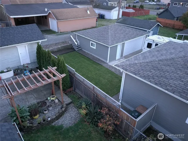 an aerial view of a house with a yard