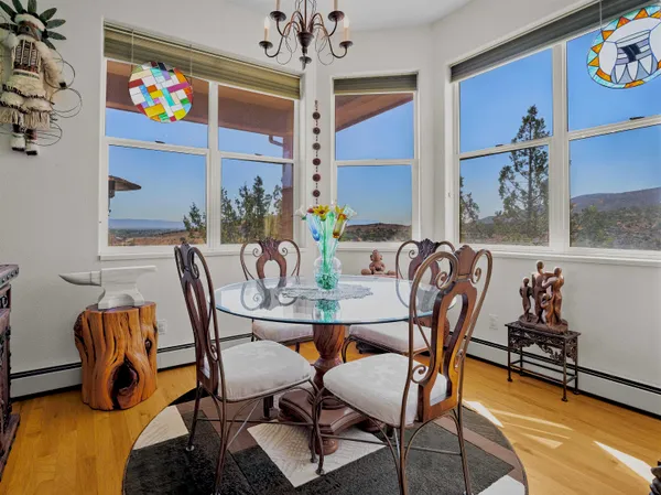 a view of a dining room with furniture and chandelier