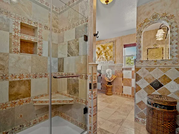 a bathroom with a granite countertop shower