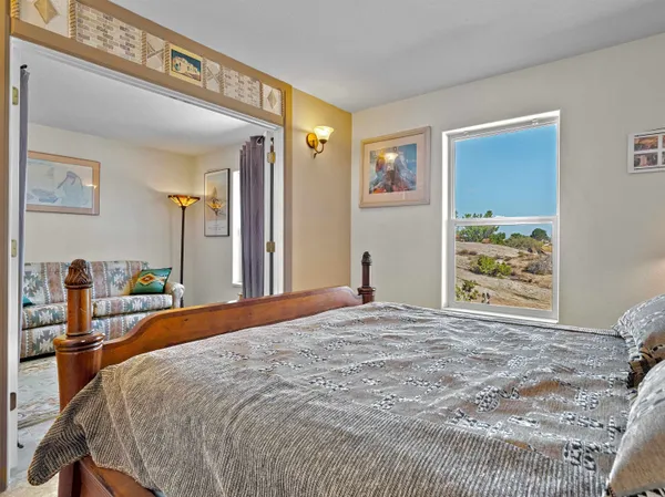 a bedroom with a large bed and a window