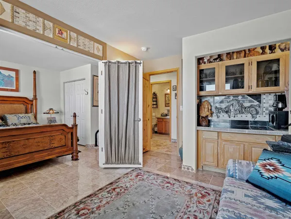 a bedroom with furniture and a rug