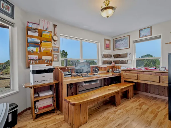 a view of a room with kitchen island stainless steel appliances wooden floor and window