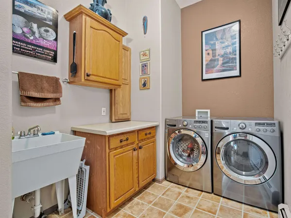 a utility room with a sink a washer and dryer