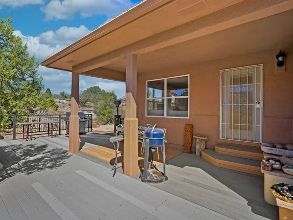 a view of a house with backyard porch and sitting area