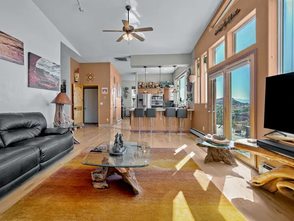 a living room with patio furniture and a flat screen tv