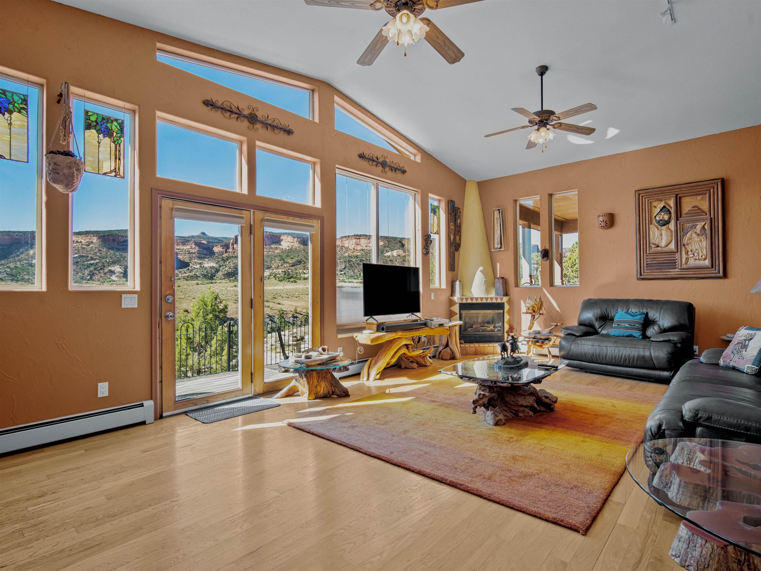 945 Prince Court Fruita, CO 81521 - Photo 8 of 38 a view of a livingroom with furniture hardwood floor and a ceiling fan