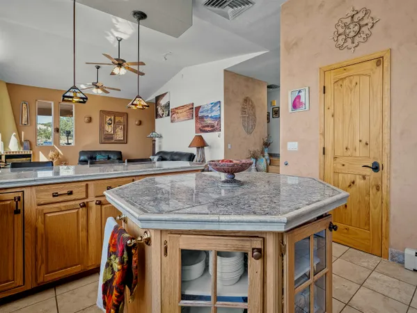 a kitchen with stainless steel appliances granite countertop a sink a stove and a wooden cabinets
