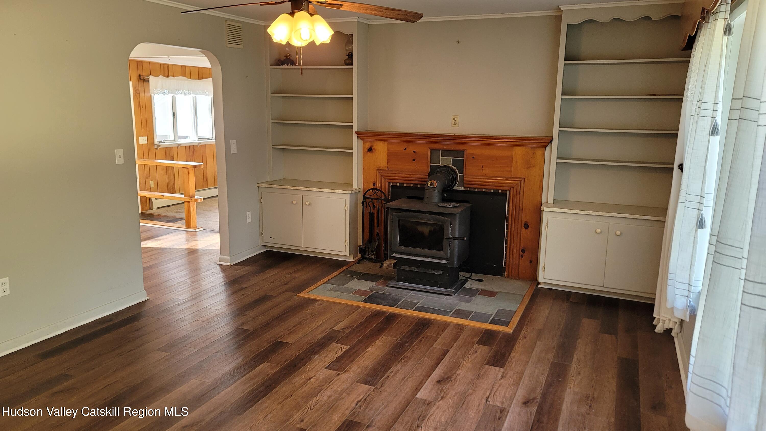 97 Ruby Road Kingston, NY 12401 - Photo 15 of 25 a view of a livingroom with wooden floor and a fireplace