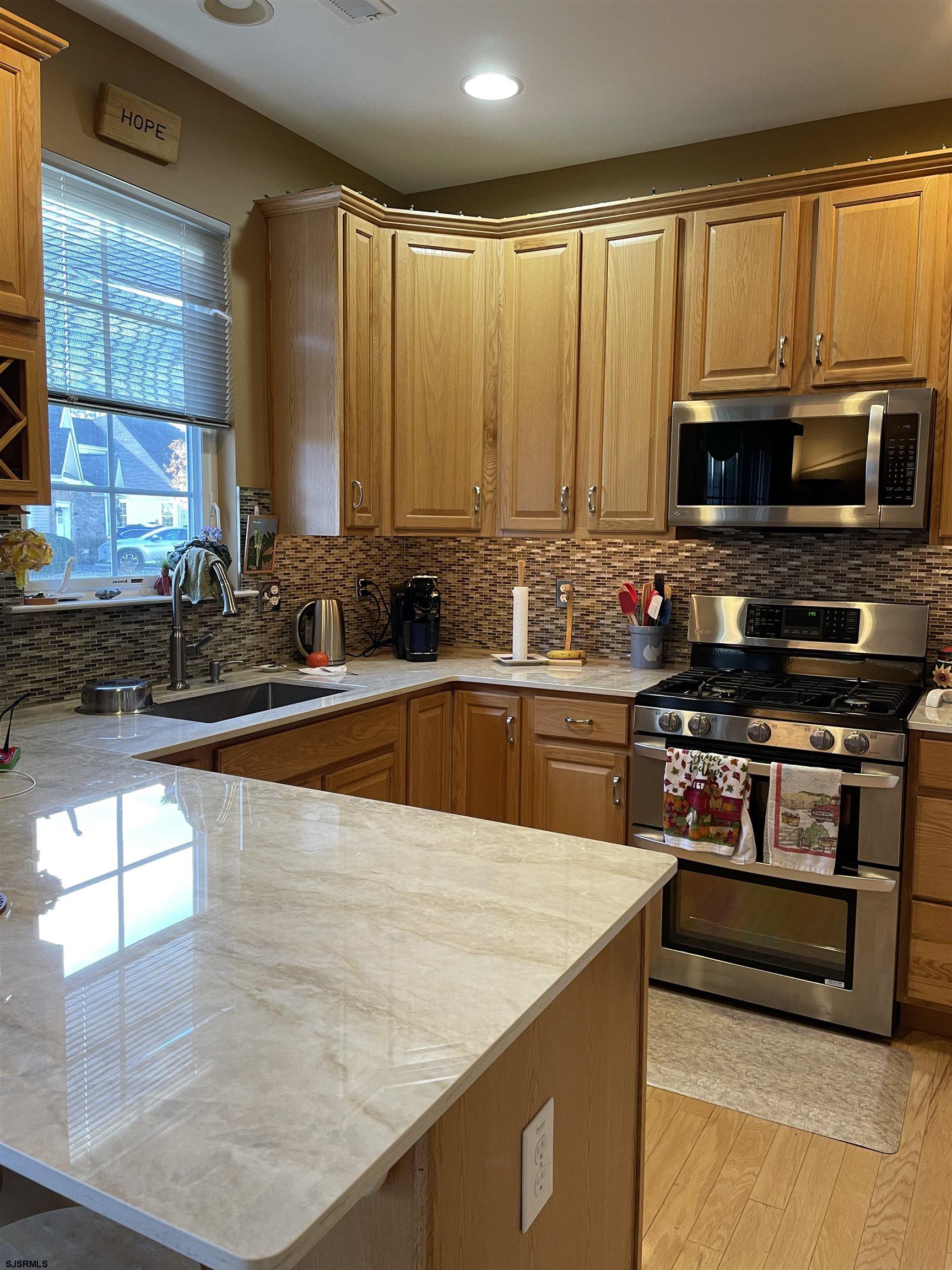 68 Ables Run Drive Absecon, NJ 08201 - Photo 7 of 28 a kitchen with stainless steel appliances a stove sink and microwave