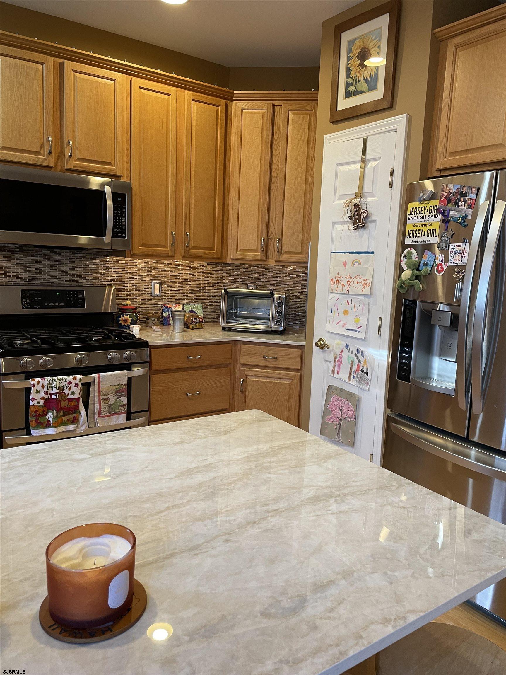 68 Ables Run Drive Absecon, NJ 08201 - Photo 8 of 28 a kitchen with stainless steel appliances a stove microwave and refrigerator