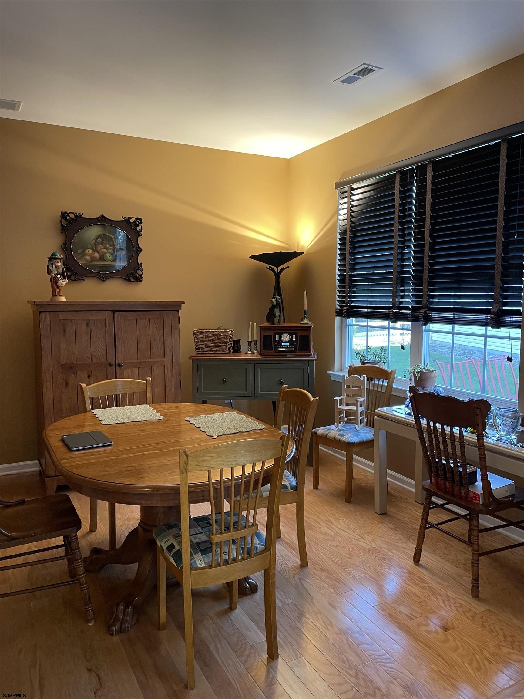 68 Ables Run Drive Absecon, NJ 08201 - Photo 9 of 28 a view of a dining room with furniture and wooden floor