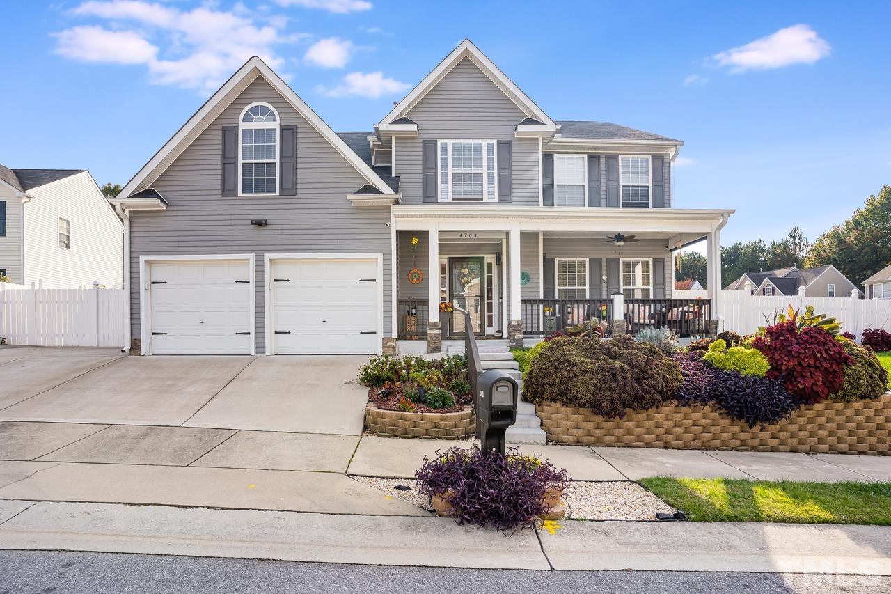 4704 Jelynn Street Raleigh, NC 27616 - Photo 1 of 30 a front view of a house with a yard and potted plants