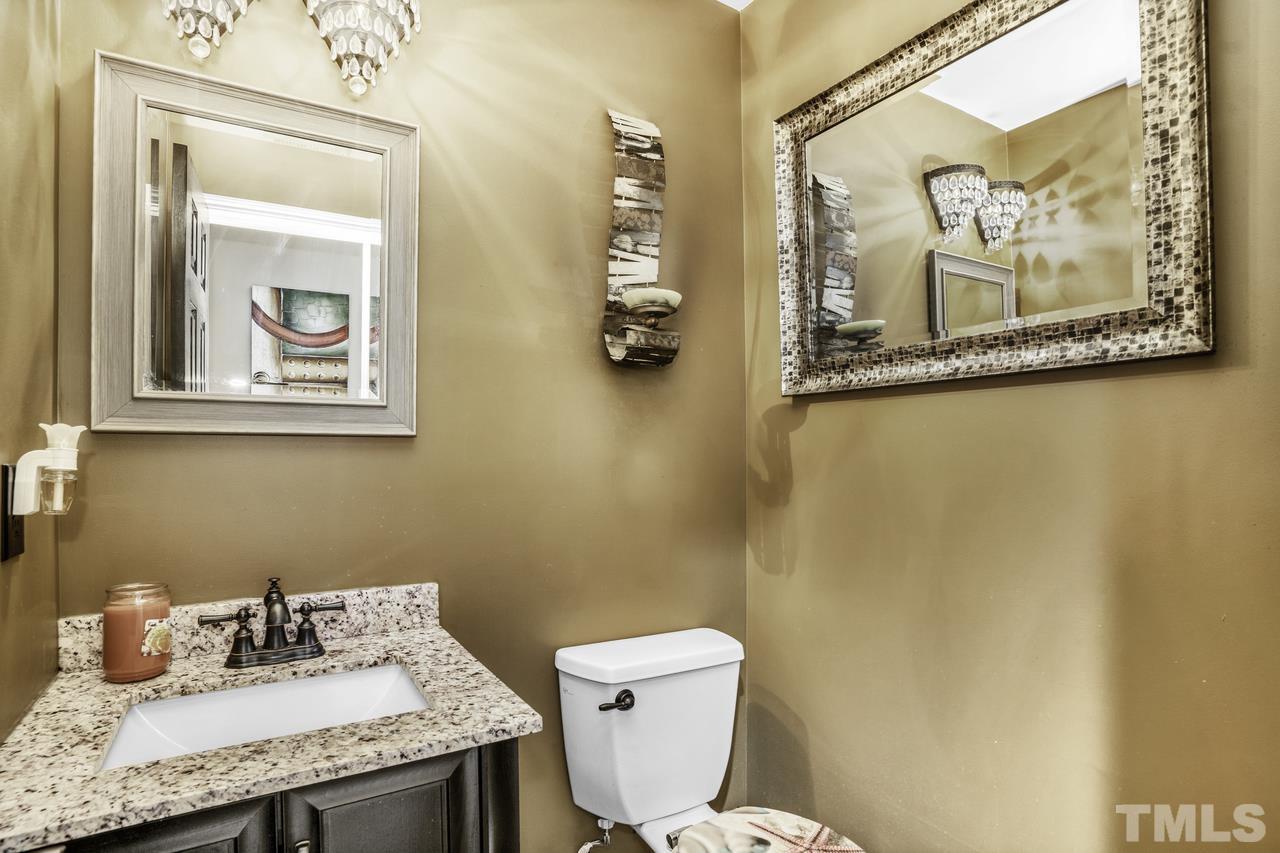 4704 Jelynn Street Raleigh, NC 27616 - Photo 15 of 30 a bathroom with a granite countertop sink mirror vanity and toilet